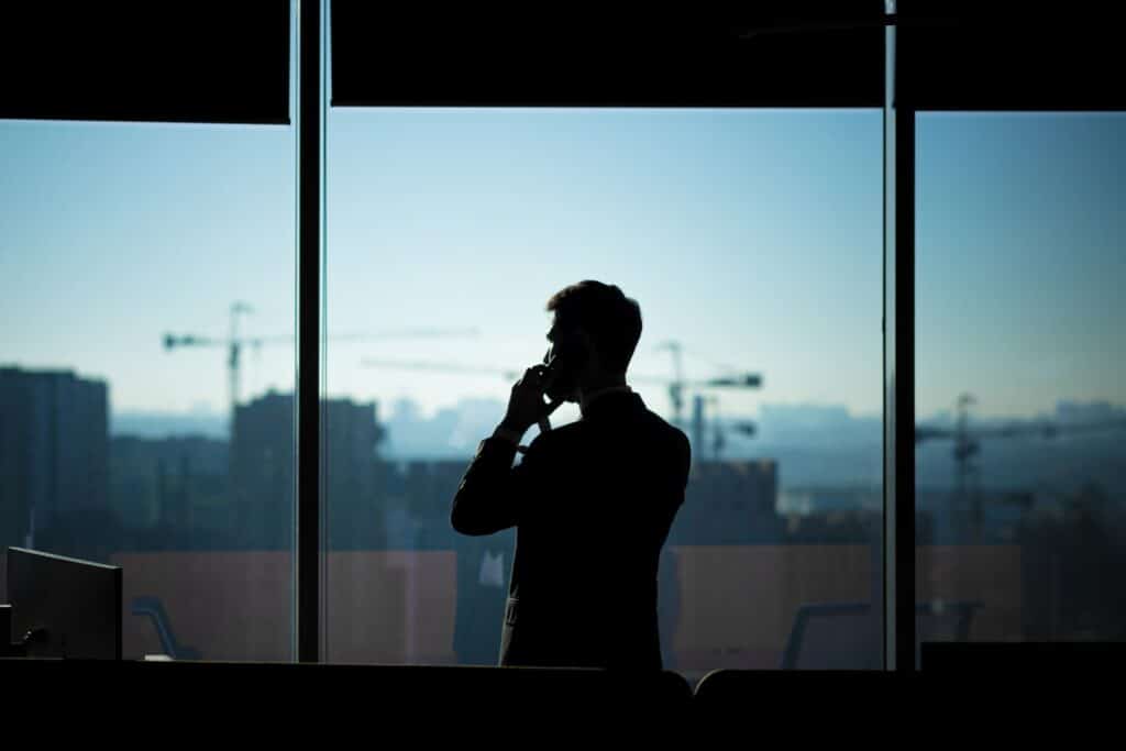business man at window in a shadow