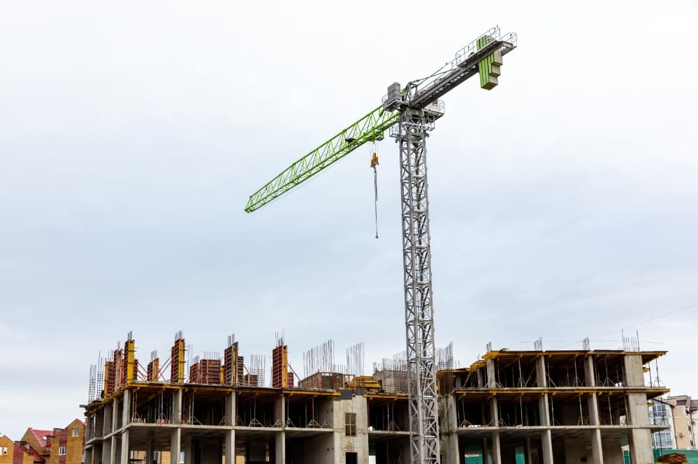 Crane over a mid rise building under construction